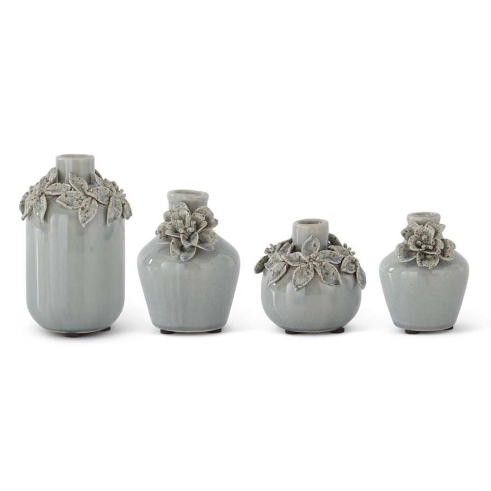 Set of four grey ceramic bud vases with hand-sculpted floral details on a plain white background.