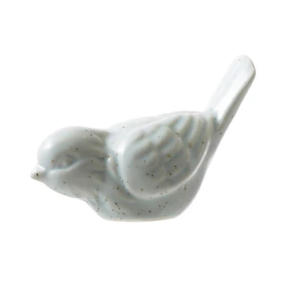 Light blue matte stoneware bird figurine with speckled detail and raised wing texture on a white background.