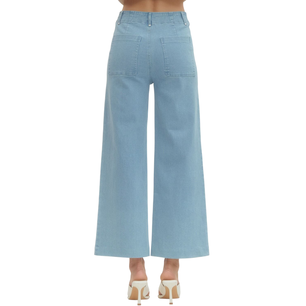 Back view of a person wearing light blue, high-waisted, wide-leg pants with two large back pockets.