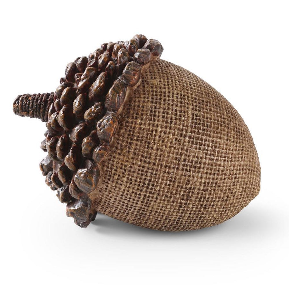 Decorative acorn featuring a textured light brown woven base and a textured dark brown resin cap.