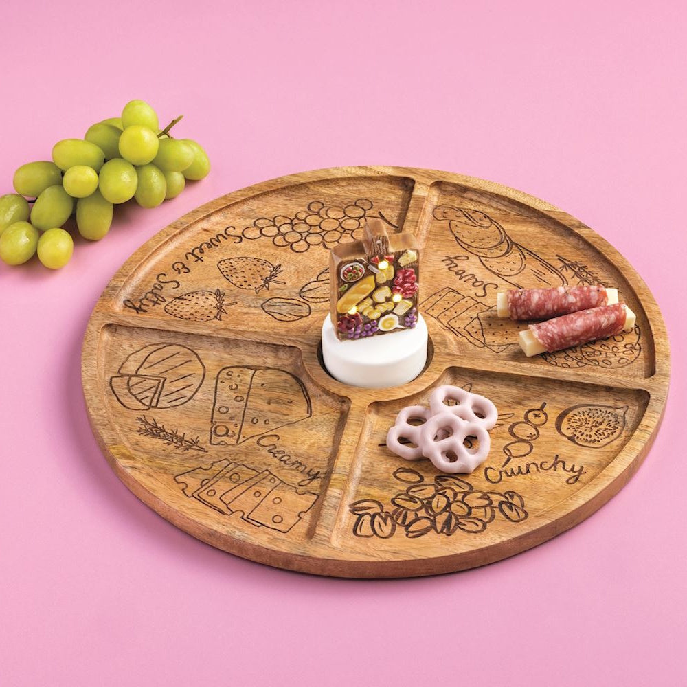 Engraved wooden charcuterie tray with labeled sections, meat, and pretzels, featuring a light-up decorative sitter.