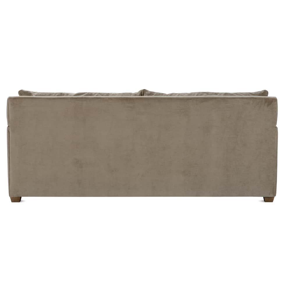 Rear view of a modern Lilah sofa upholstered in smooth taupe velvet fabric with short wooden legs.
