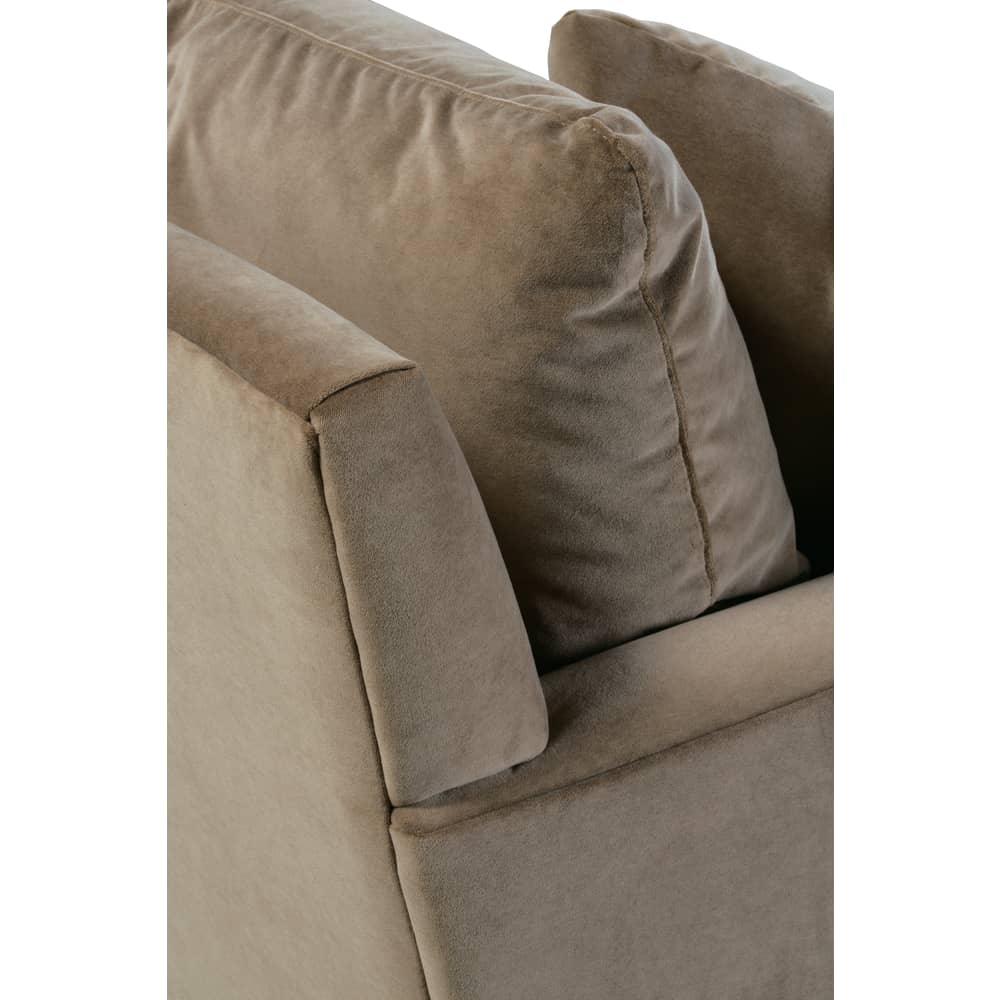 Close-up of a taupe velvet sofa showing the plush back cushions and smooth fabric texture.
