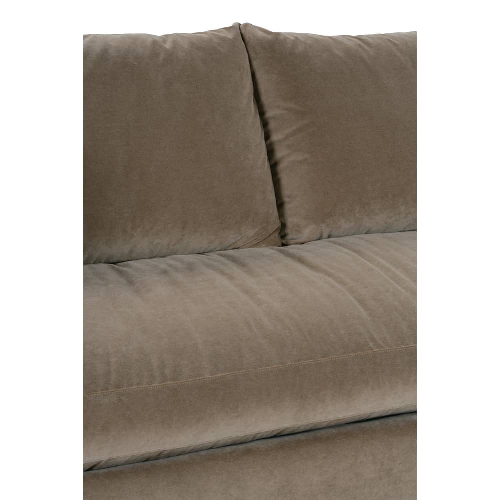 Close-up of a modern beige velvet sofa highlighting plush seat and back cushion details.