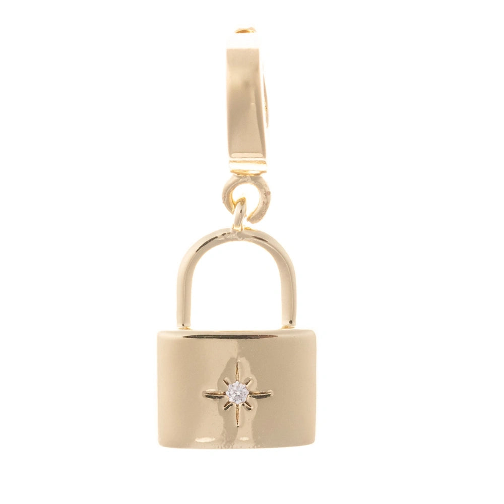 Gold padlock charm featuring a starburst-set clear crystal accent on a plain white background.