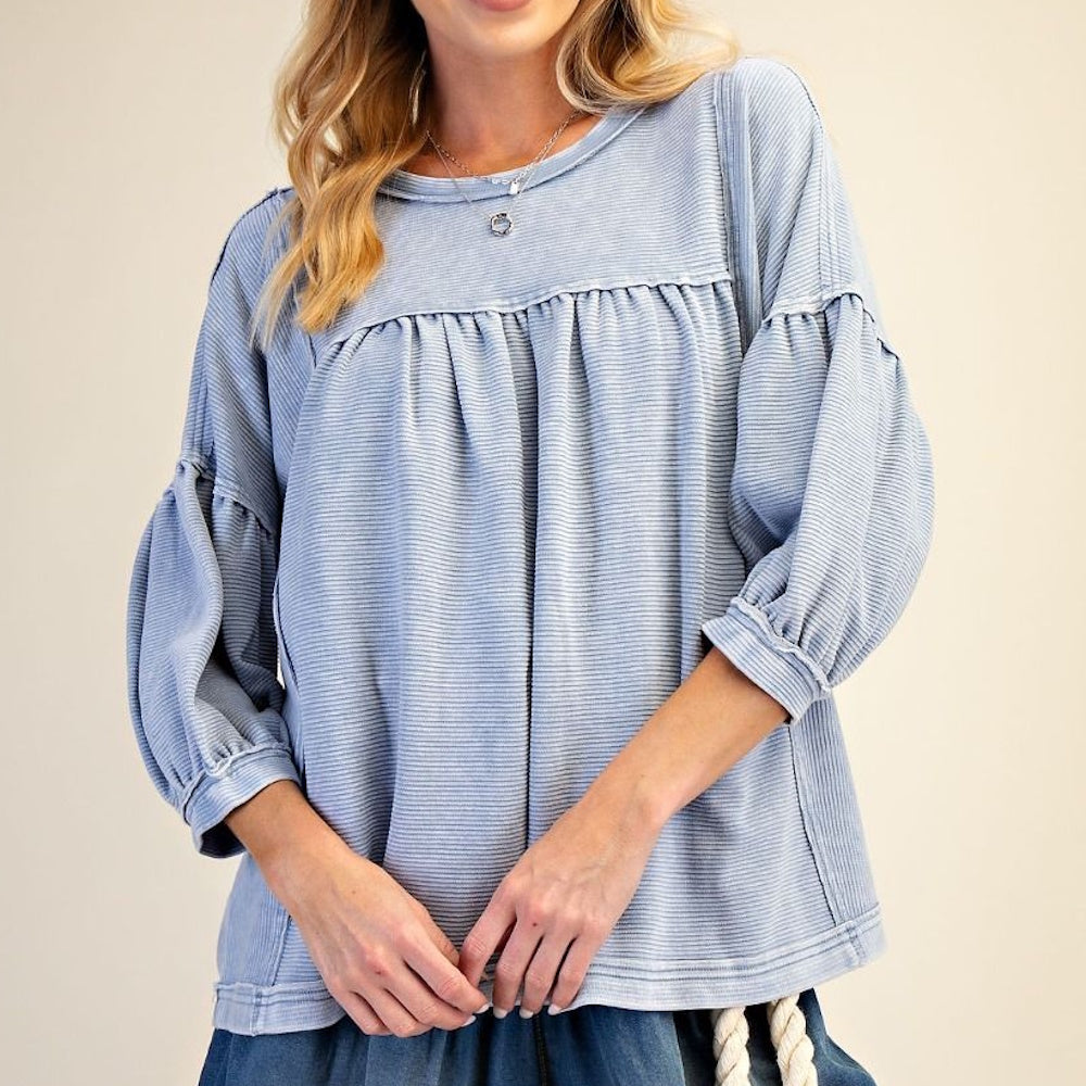 Light blue mineral wash babydoll top with textured ribbed knit, long balloon sleeves, and a relaxed fit.