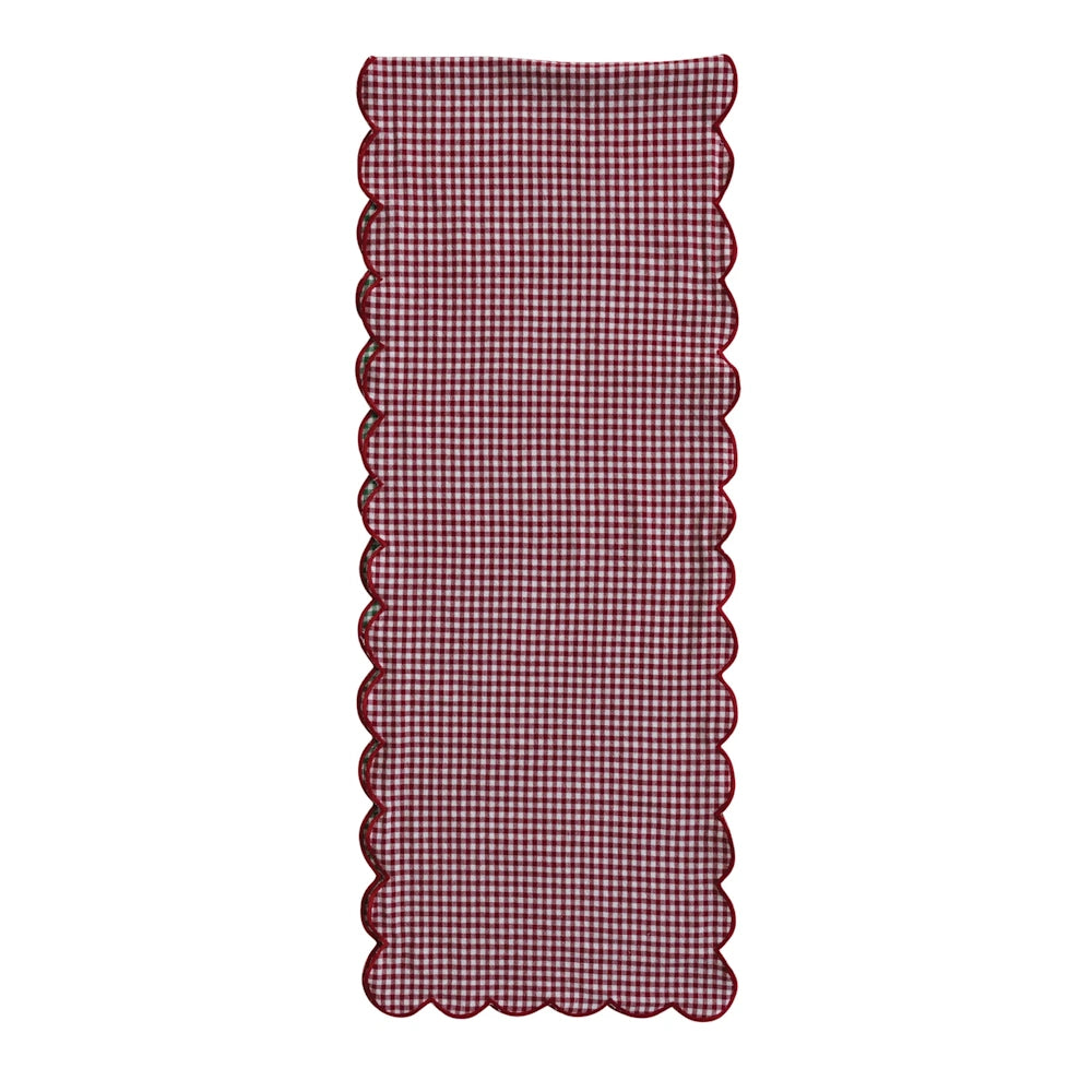 Long red and white gingham table runner featuring red scalloped edges against a clean white background.