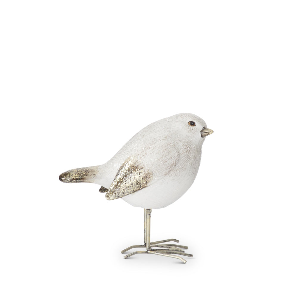 White and gold glittered bird figurine with its head tilted up, standing on thin metal legs against white.