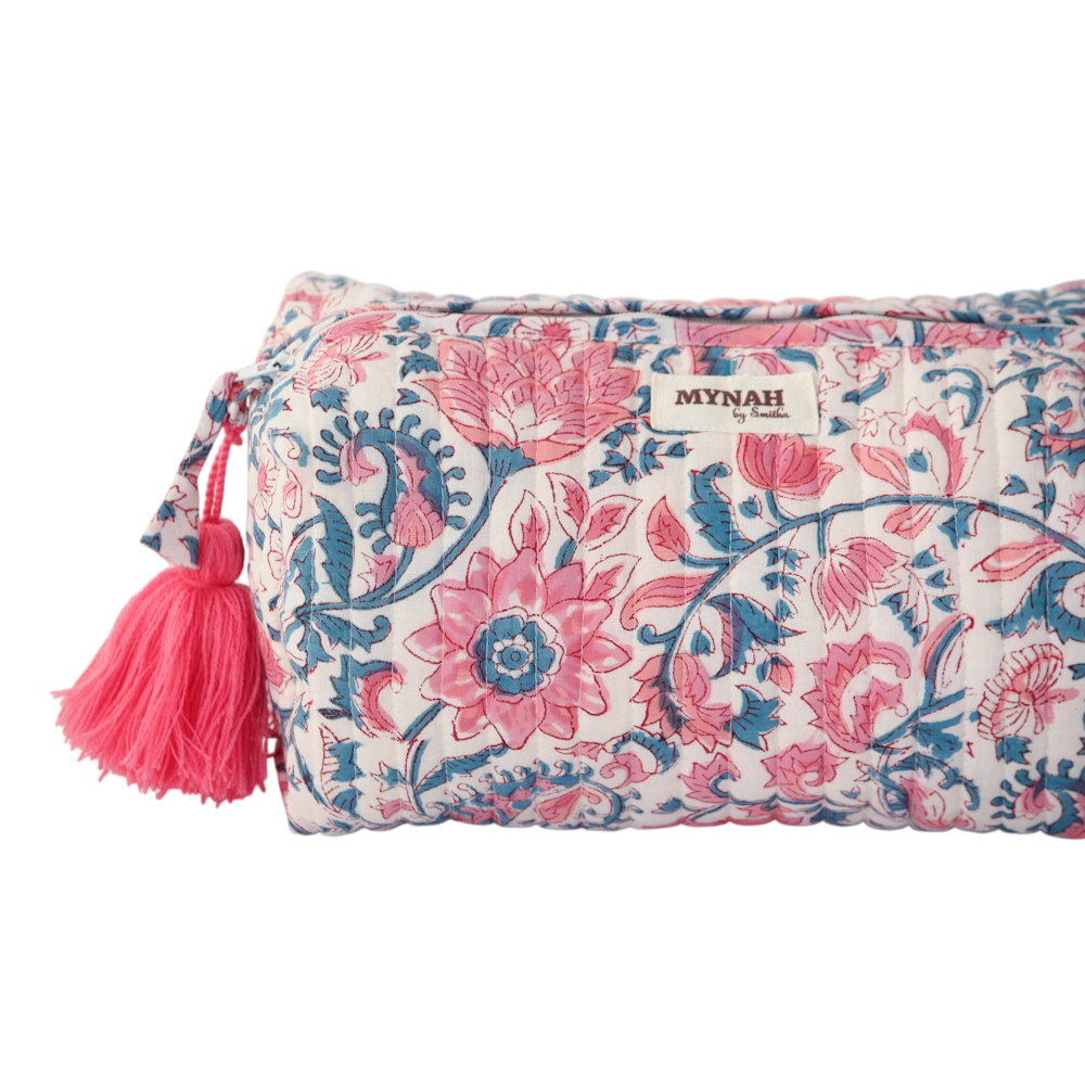 Quilted block-print makeup pouch with pink lotus flowers, blue paisley patterns, and a matching tassel.