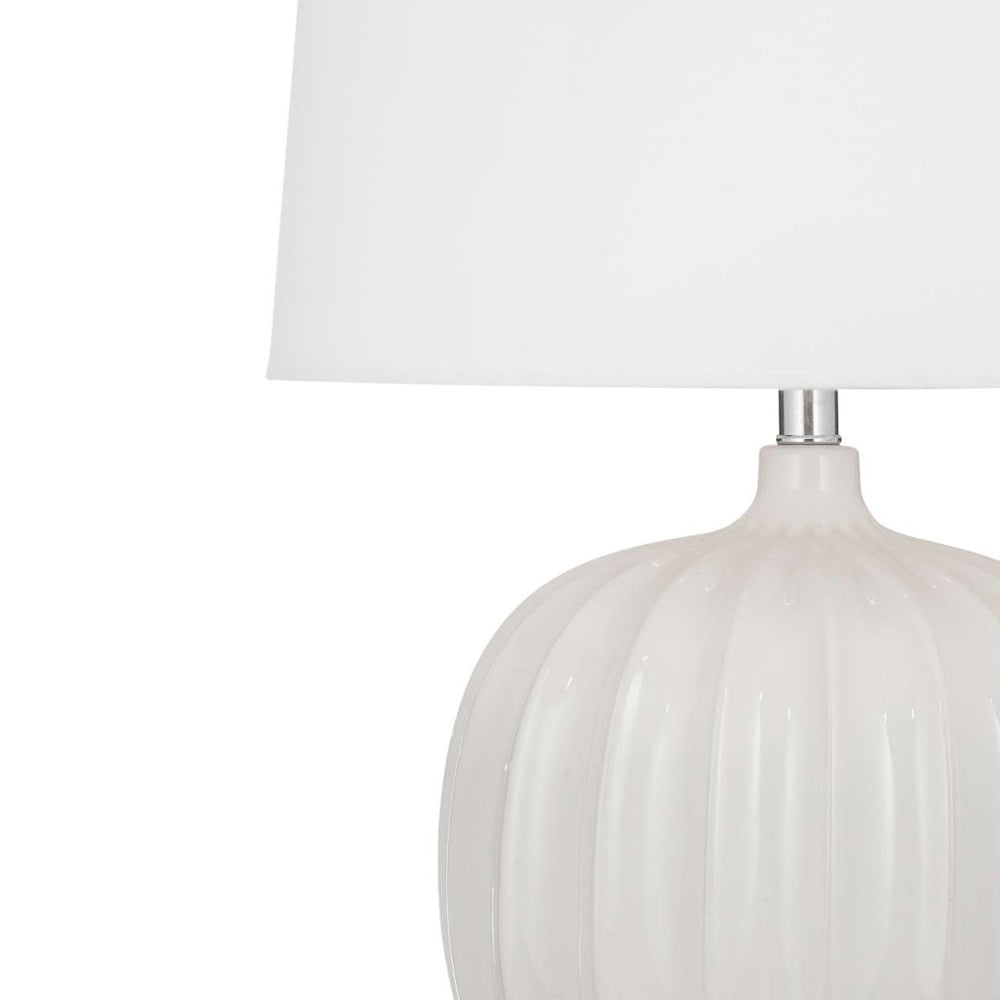 White fluted ceramic table lamp with a round ribbed base and a classic white fabric drum shade.
