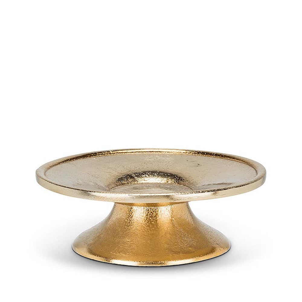Textured brass pedestal candle plate with a low, flared base on a white background.