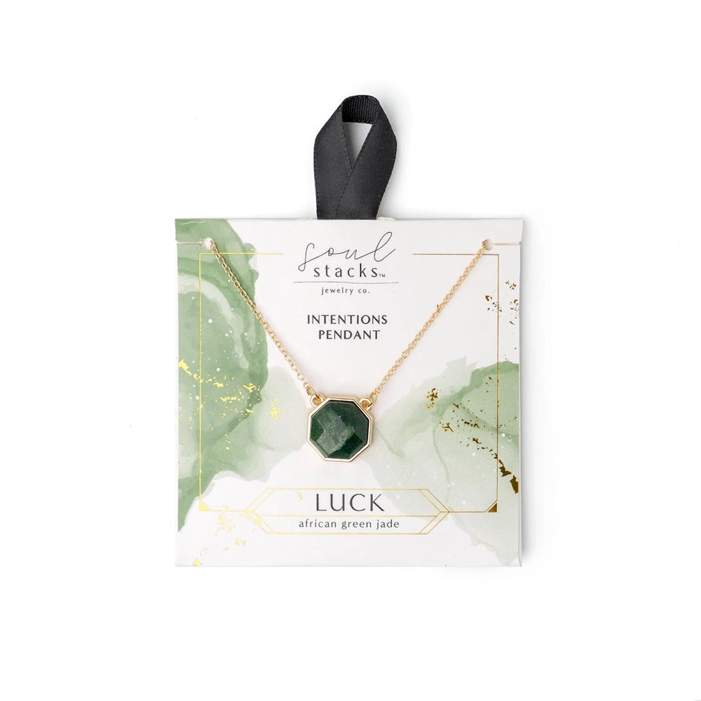 Soul Stacks African Green Jade Luck Intentions Pendant on a gold chain, displayed on green watercolor themed packaging.