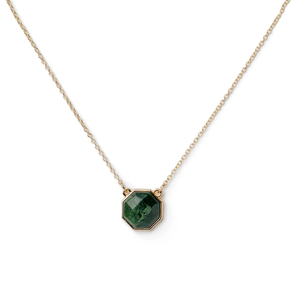 A delicate gold chain necklace with a faceted emerald-green moss agate pendant.