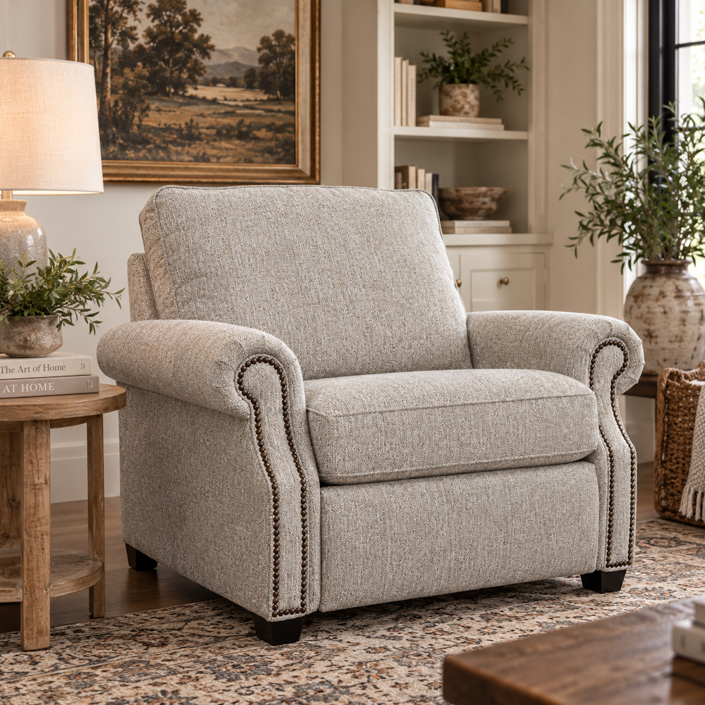 Grey power recliner with rolled arms and nailhead trim in a furnished living room setting.
