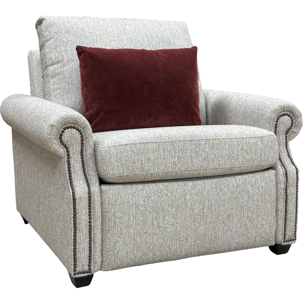 Grey power recliner with rolled arms, nailhead trim, and a dark red lumbar pillow on a white background.