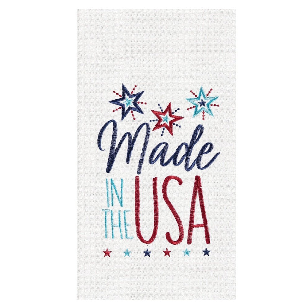 White waffle knit towel with "Made in the USA" embroidered in red, blue, and teal with decorative stars.