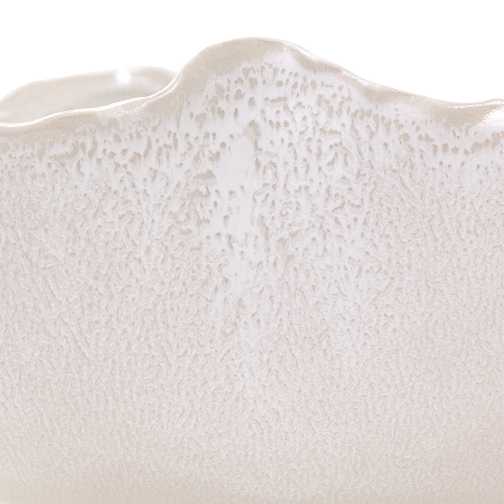 Close-up of Magnus ceramic bowl featuring a textured reactive glaze and an organic wavy rim.