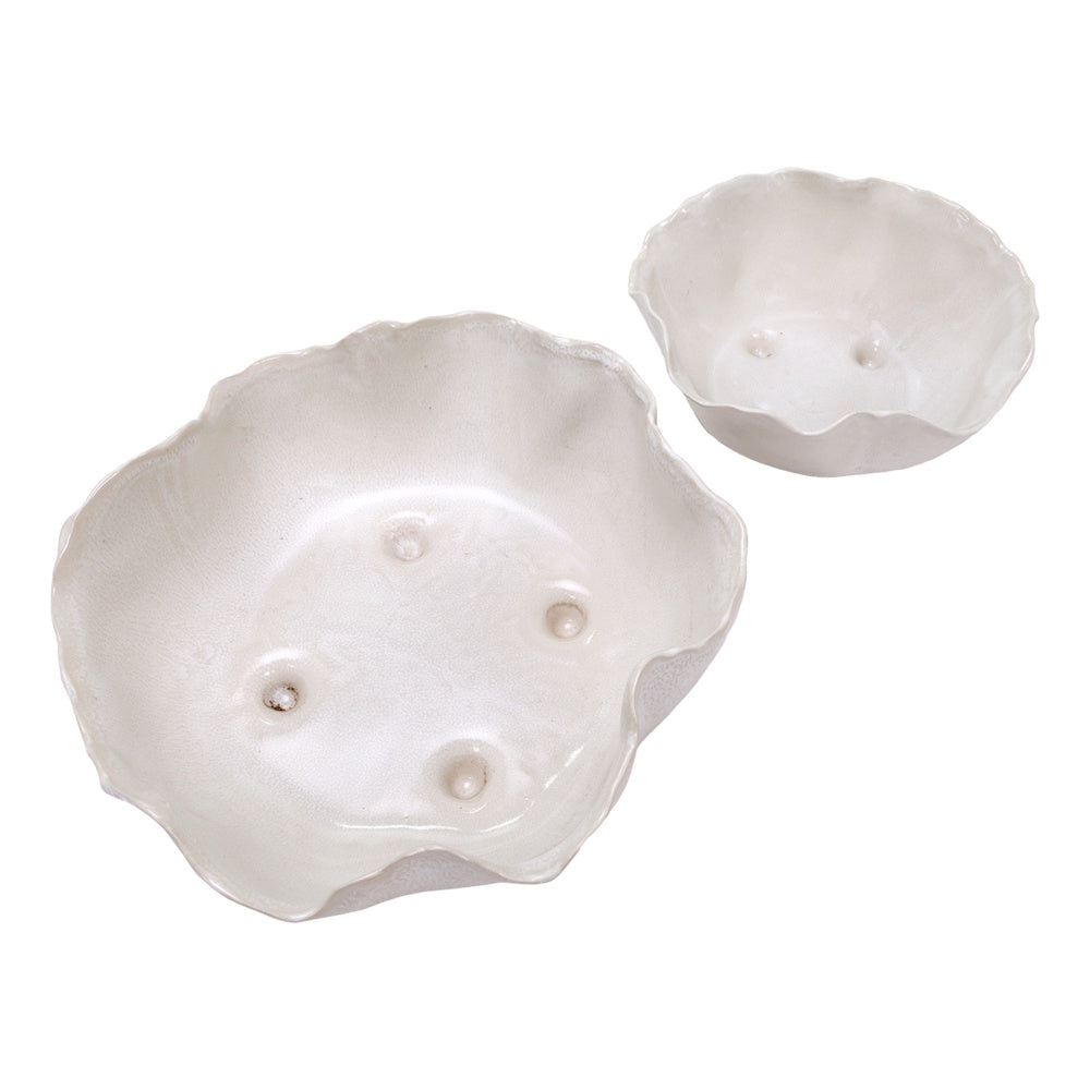 Top-view of Magnus white ceramic wavy nesting bowls with a reactive glaze and organic scalloped edges.