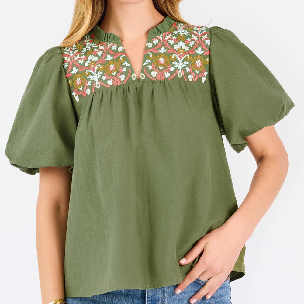 Olive green top featuring floral embroidery along the split neckline and short puff sleeves.