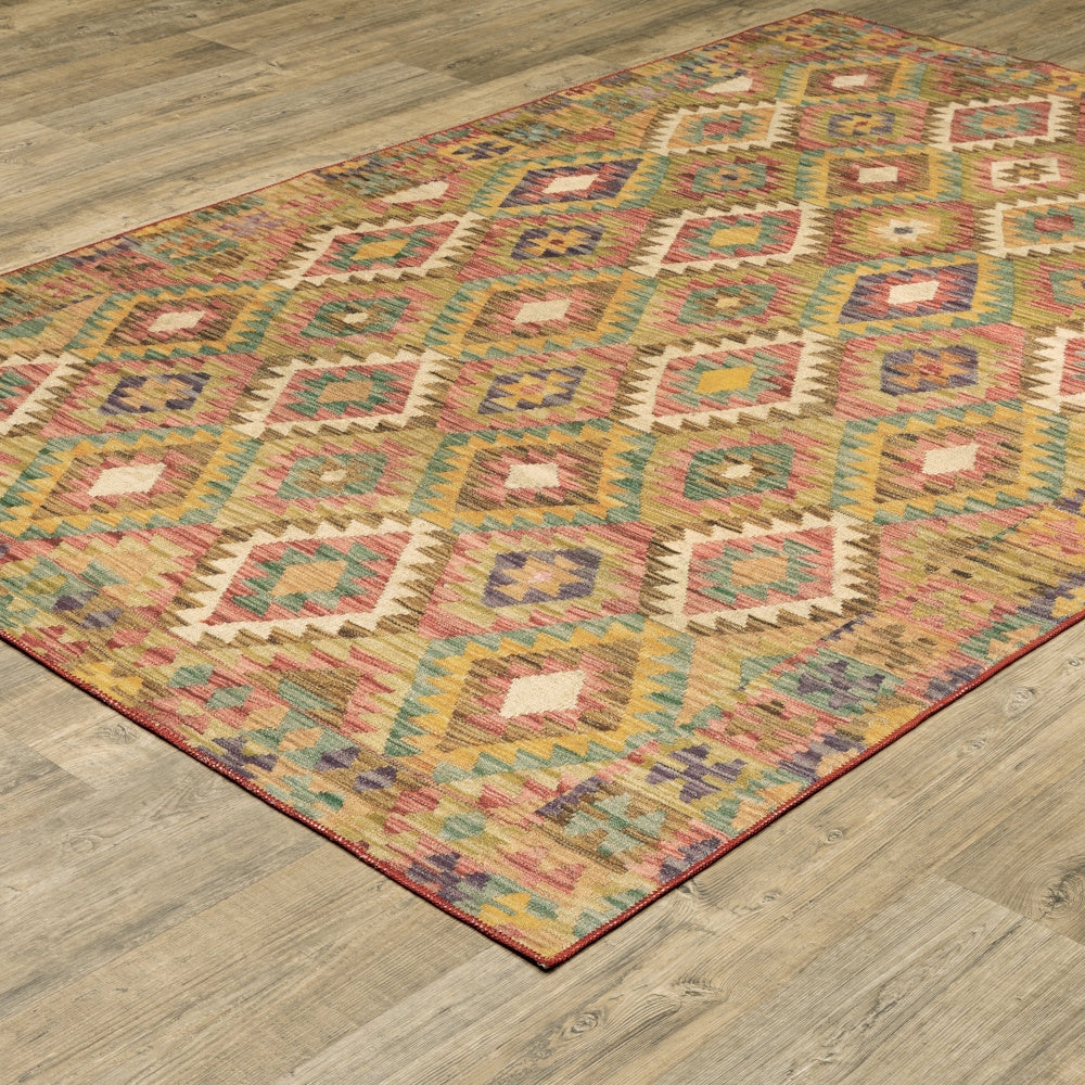 A colorful, geometric diamond-patterned area rug on a light wood floor, shown from an angled perspective.