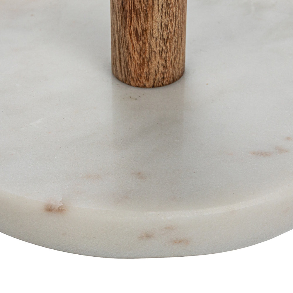 Close-up of a wooden post anchored into a circular white marble base with natural grey and tan veining.