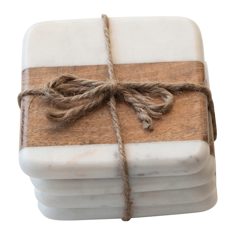 Stack of square white marble and wood coasters tied together with a rustic twine bow.