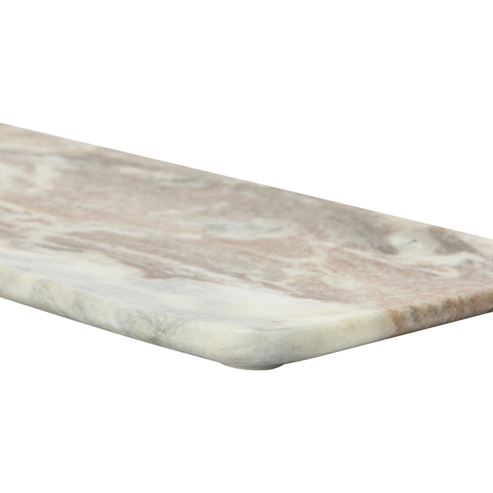 Close-up of the rounded corner and smooth edge of a pink and white veined marble serving board.