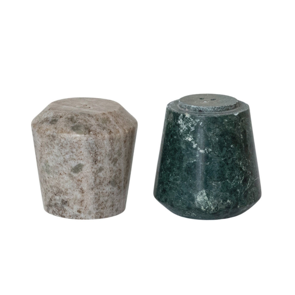 A pair of stackable marble salt and pepper shakers, one speckled beige and one dark green.