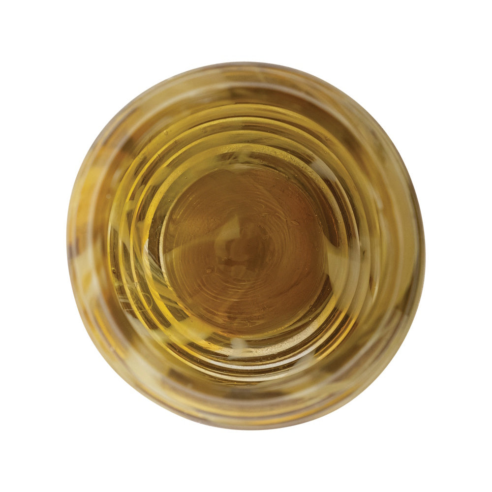 Top-down view looking into a round, ribbed amber glass vase with concentric circles on a white background.