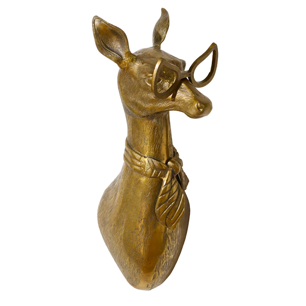 Gold sculpture of a deer bust wearing retro glasses and a neck scarf on a white background.