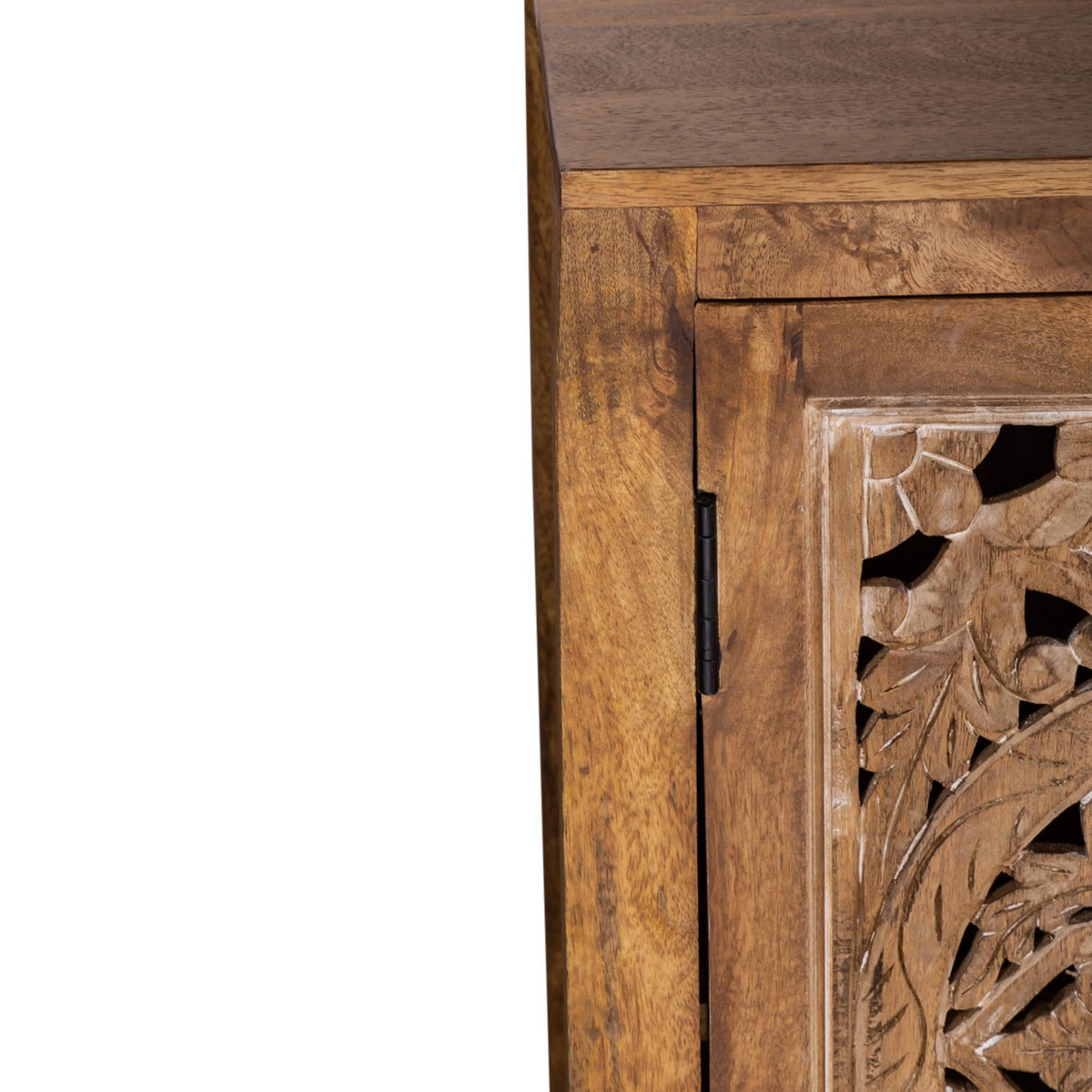Close up of mango wood TV stand corner with carved floral door panel and black hinge detail.