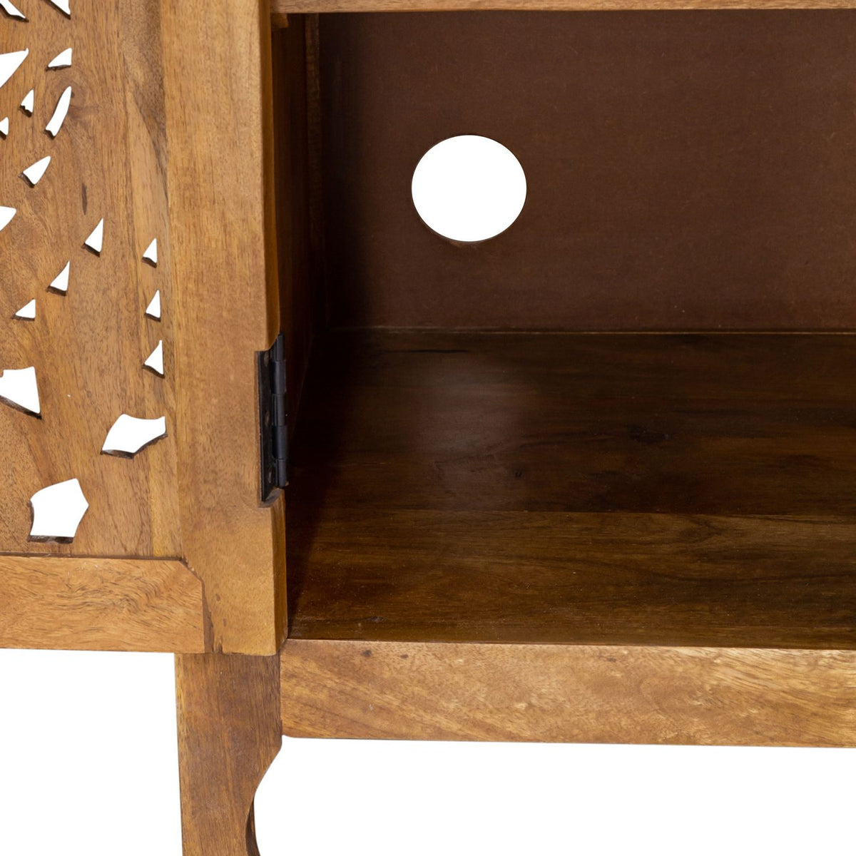 Inside view of mango wood TV stand cabinet with carved door, black hinge and rear cable hole.
