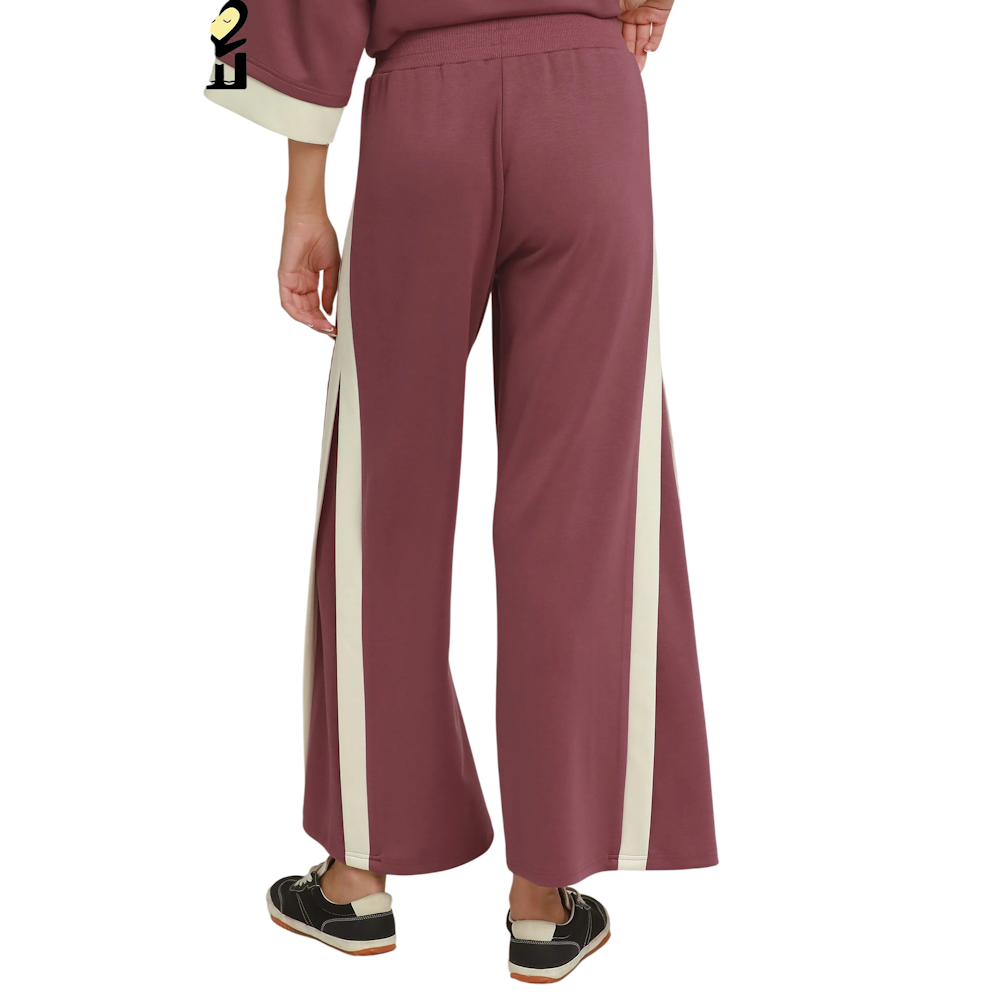 Back view of wide-leg marsala pants featuring cream side stripes and an elasticized high waistband.