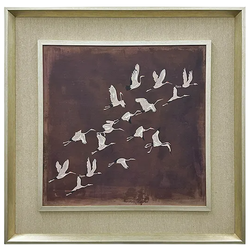 Framed wall art depicting a flock of white birds in flight against a dark mauve background.