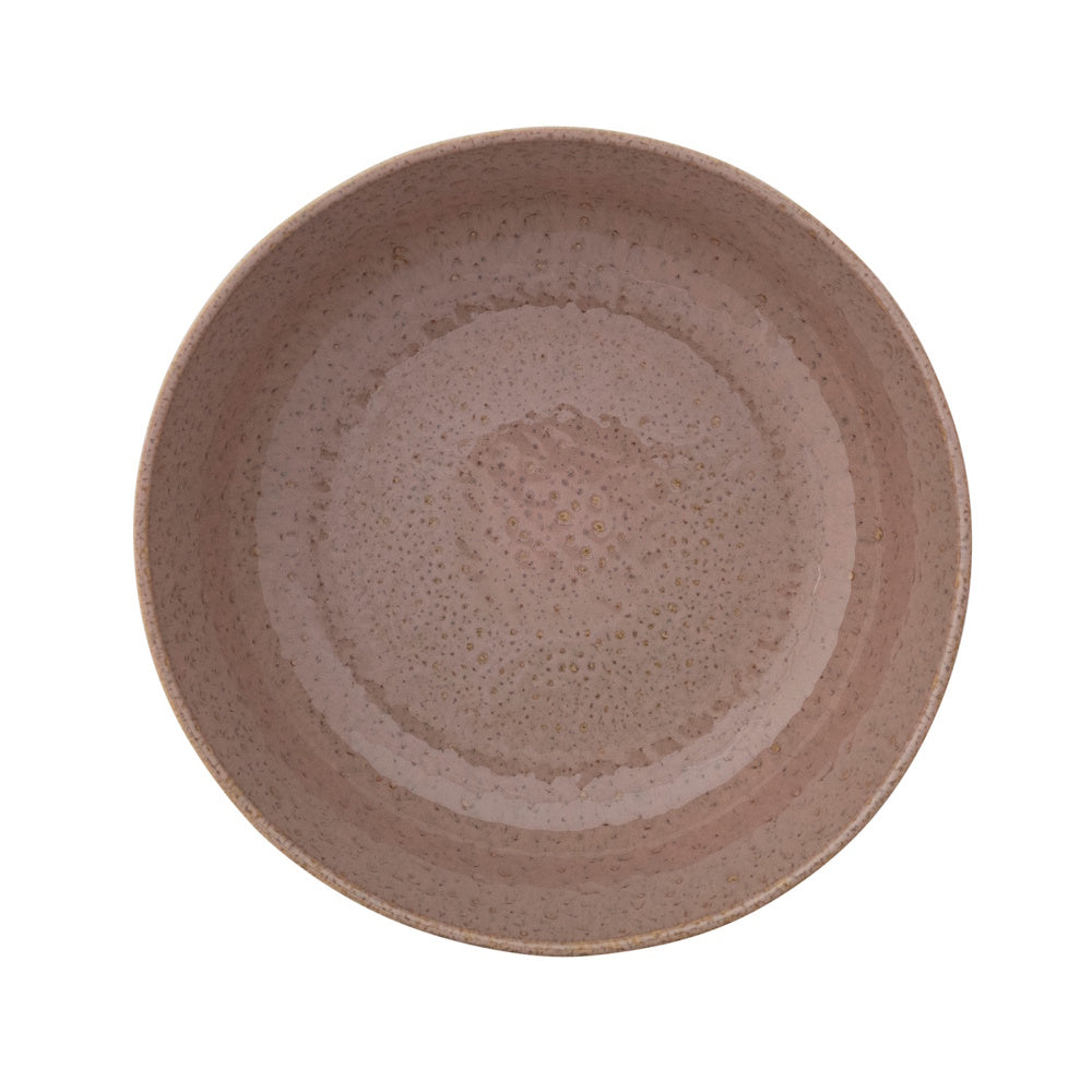 Top view of a round, mauve speckled stoneware bowl on a white background.