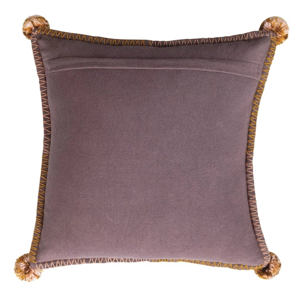 Mauve square throw pillow with orange whipstitch trim and corner pom-poms on a white background.