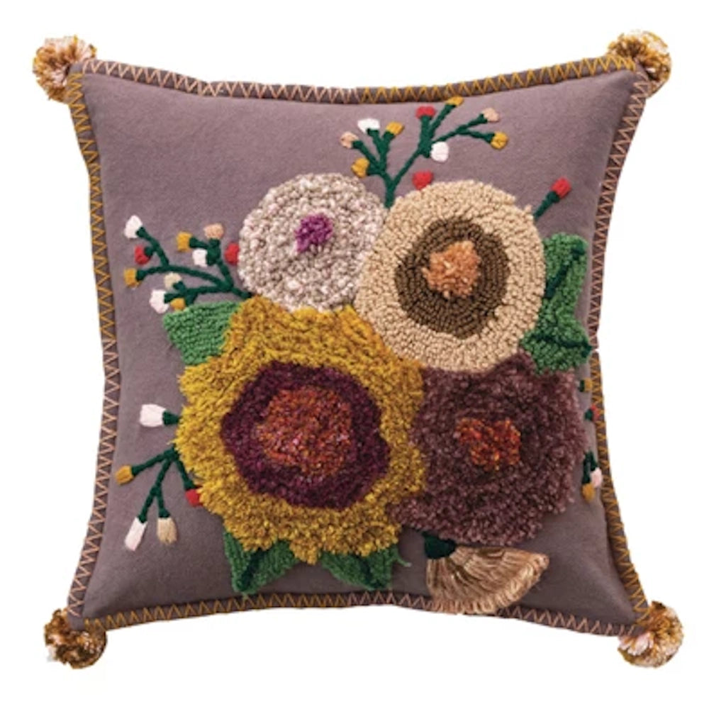 Boho decorative accent pillow featuring textured floral embroidery, yellow blossoms, and stitched edges on purple fabric.