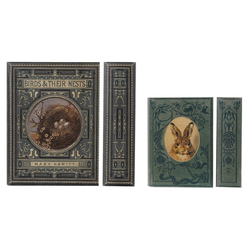 Two vintage book-style storage boxes, one featuring a bird's nest and the other a rabbit illustration.