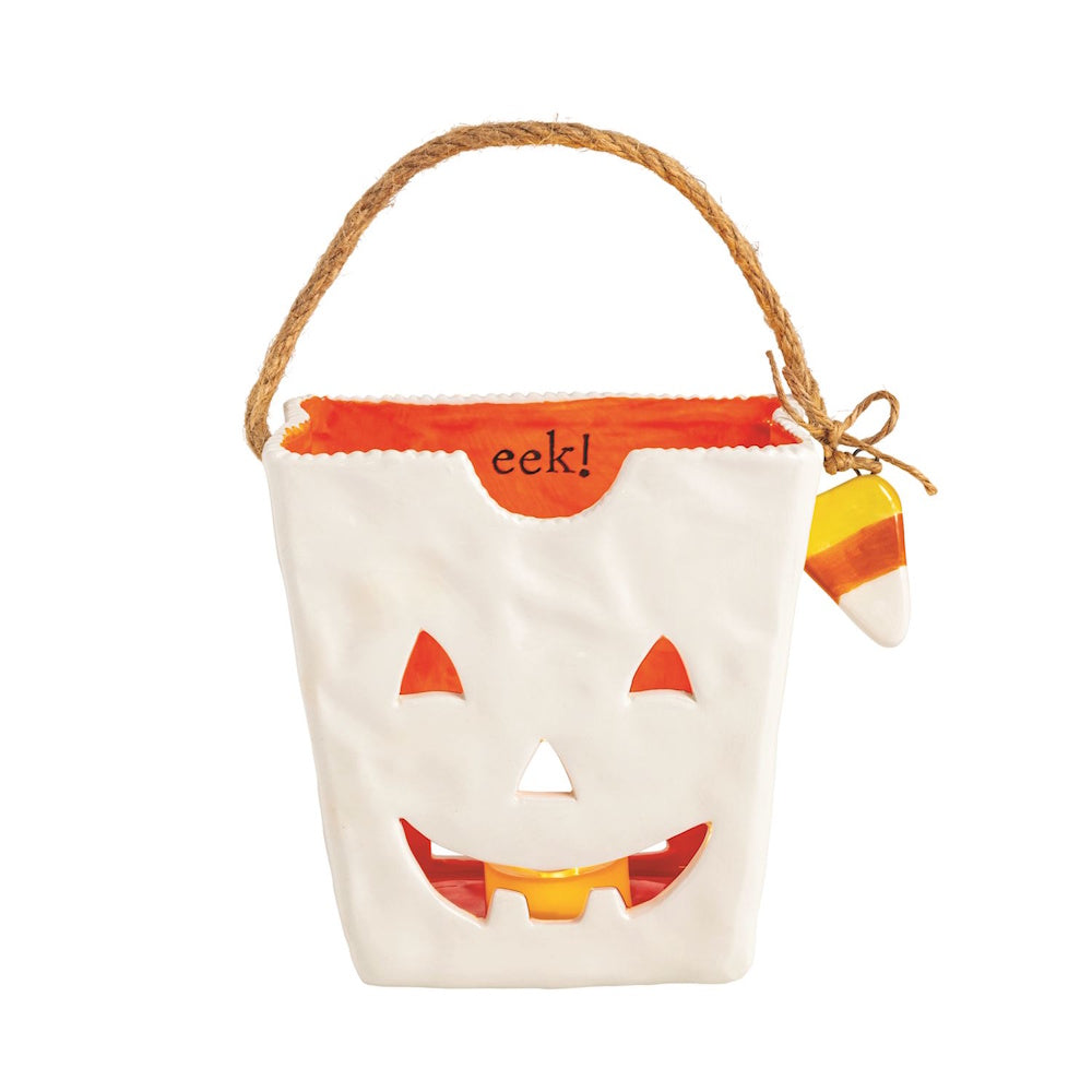 White ceramic jack-o-lantern treat bag lantern with twine handle.