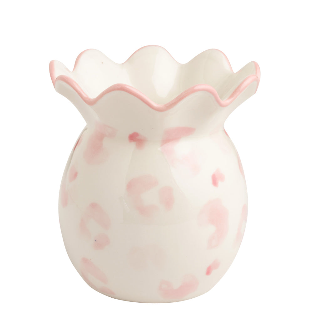 Small ceramic bud vase with pink leopard print and a scalloped rim. Chic decorative tabletop accent for flowers.
