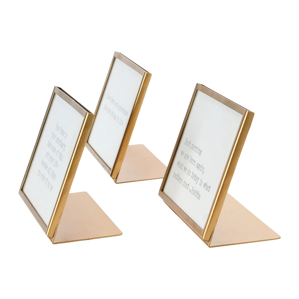 Set of three gold metal and glass tabletop picture frames with easel stands featuring inspirational quotes on a white background.