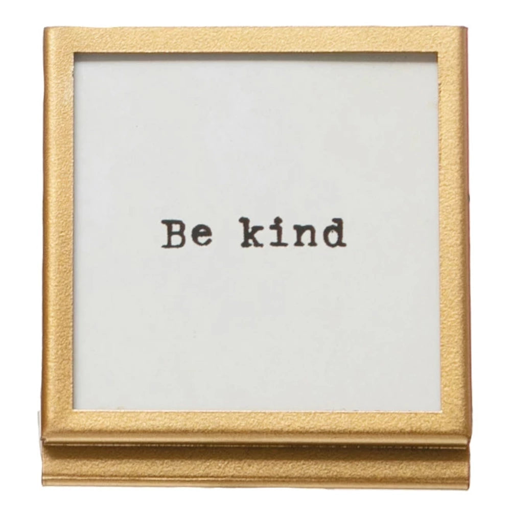 Square gold metal and glass picture frame with "Be Kind" motivational quote insert on a white background.