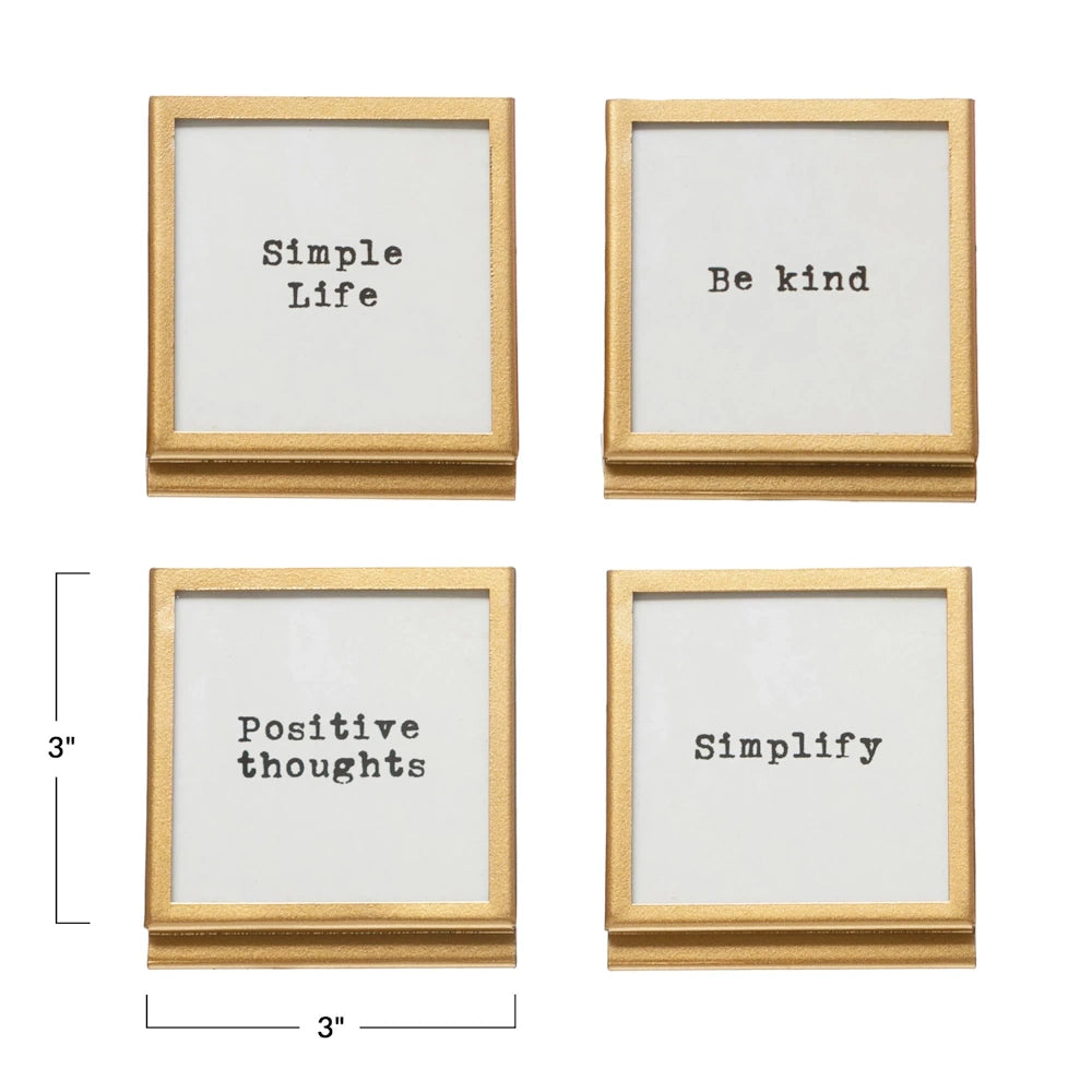 Set of four 3-inch square gold metal and glass frames with easel stands, featuring inspirational typewriter-style quotes.