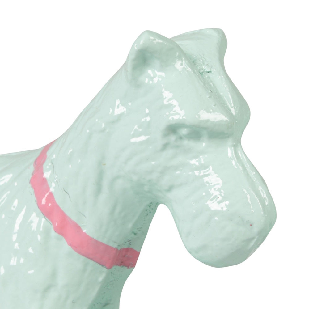 A close-up of a mint green, metal dog-shaped bookend featuring a painted pink collar against a white background.