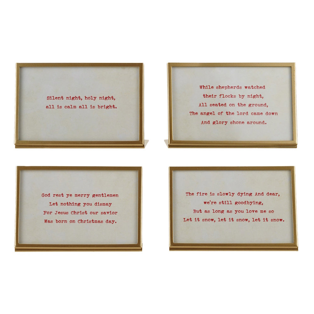 Set of four gold metal frames displaying printed red Christmas carol lyrics on a cream background.
