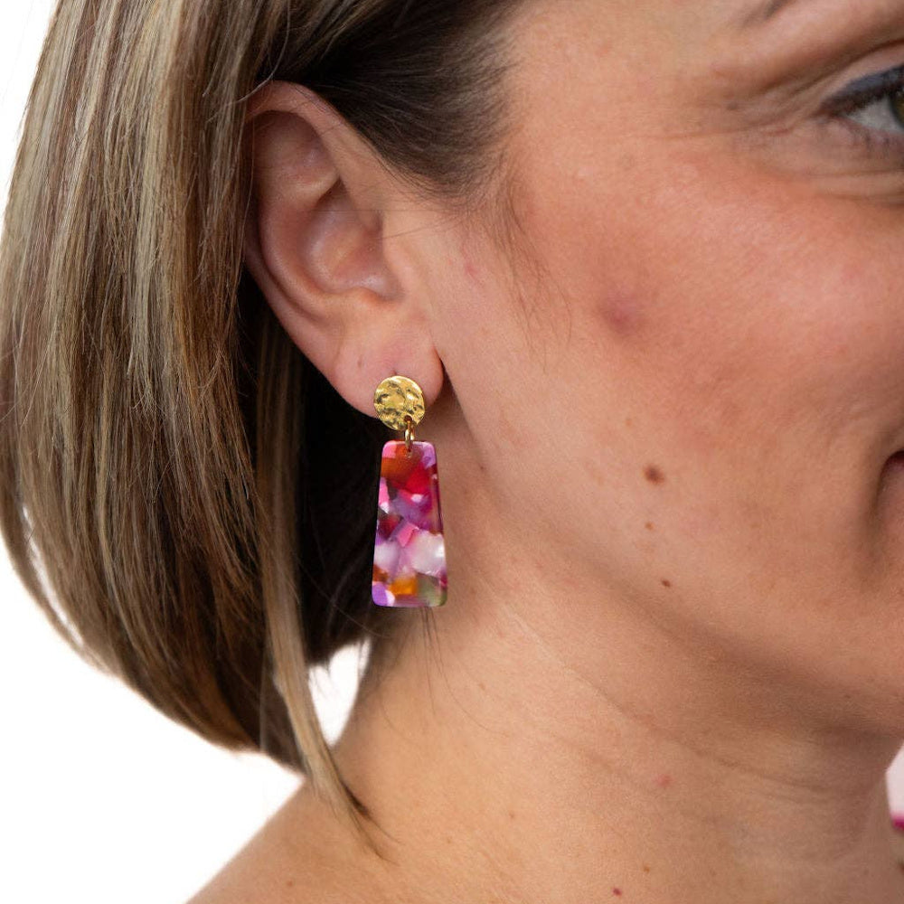 Model wearing Mia Mini pink marble acetate drop earrings with hammered gold studs for a stylish, colorful jewelry look.