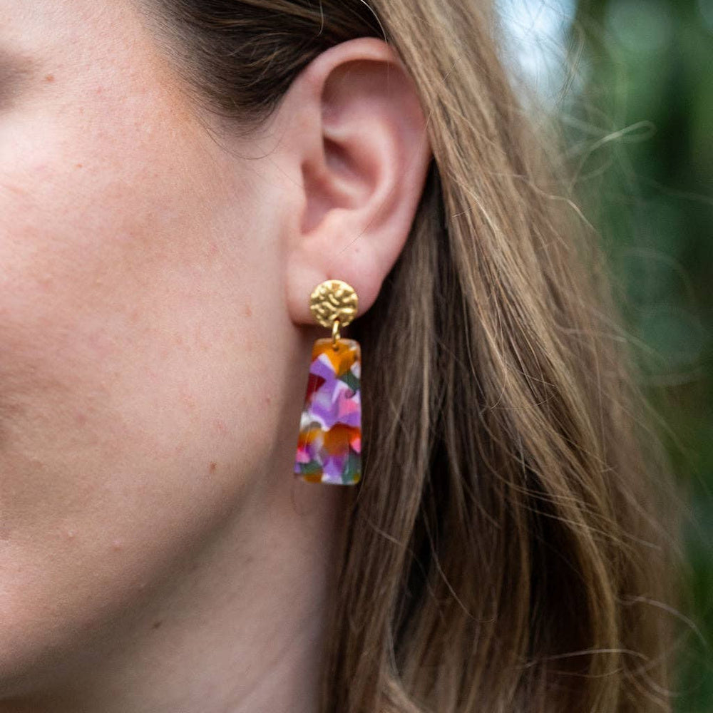 Model wearing Mia Mini paradise pink acetate drop earrings with hammered gold studs and a vibrant mosaic pattern.