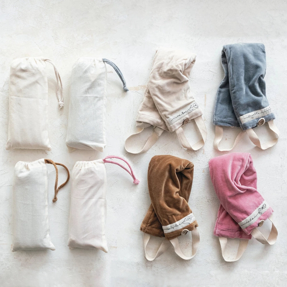 Microwavable hot and cold neck wraps in assorted velvet colors with matching drawstring storage bags for pain relief.