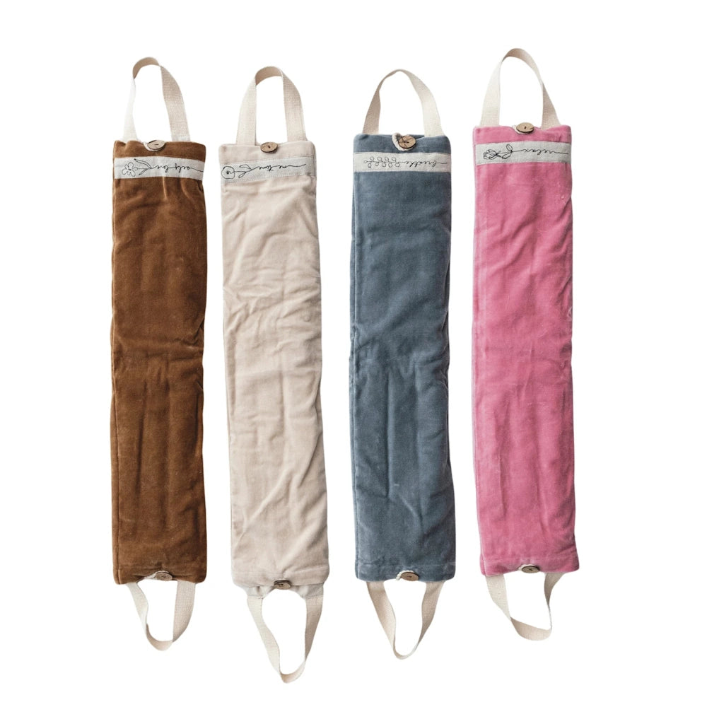 Microwavable hot and cold neck wraps in brown, cream, blue, and pink velvet with handles and button closures.
