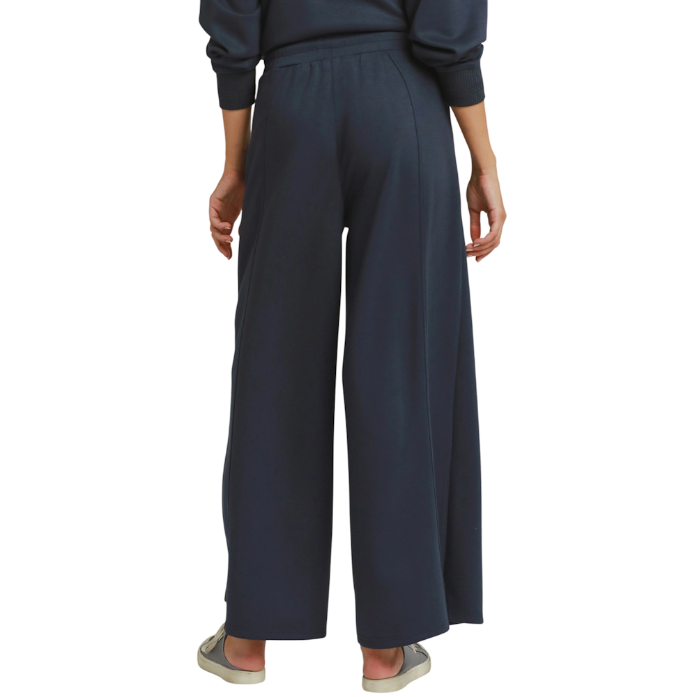 Back view of dark navy knit wide-leg pants with an elastic waist and center leg seams.